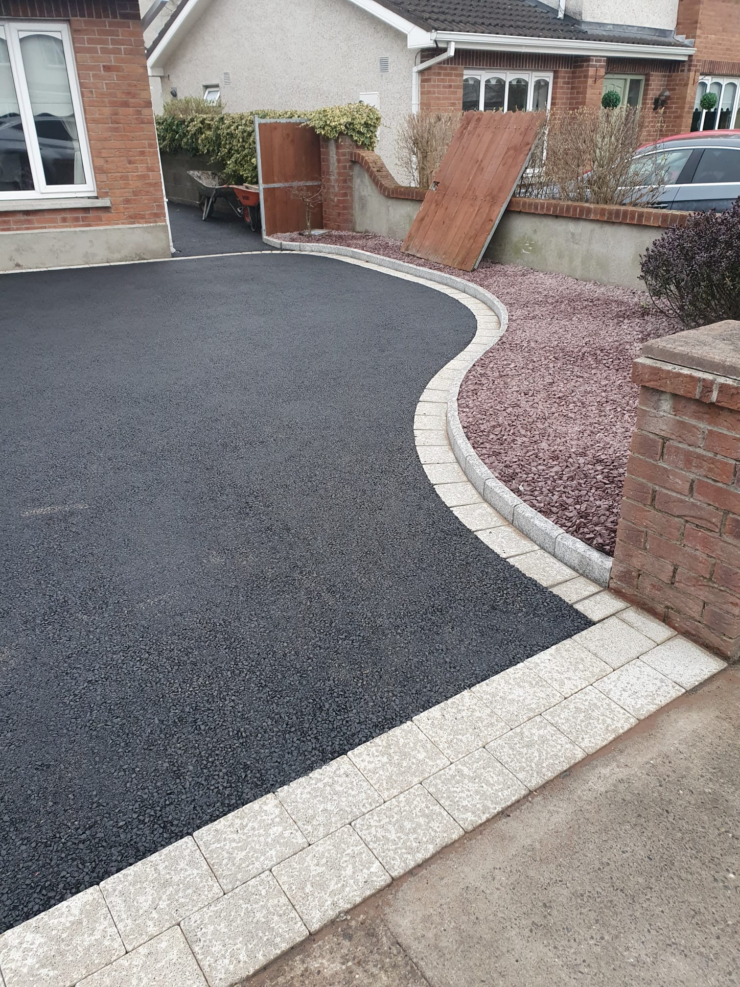 Tarmac driveway with a granite sett and pebble border detail at a Dublin home