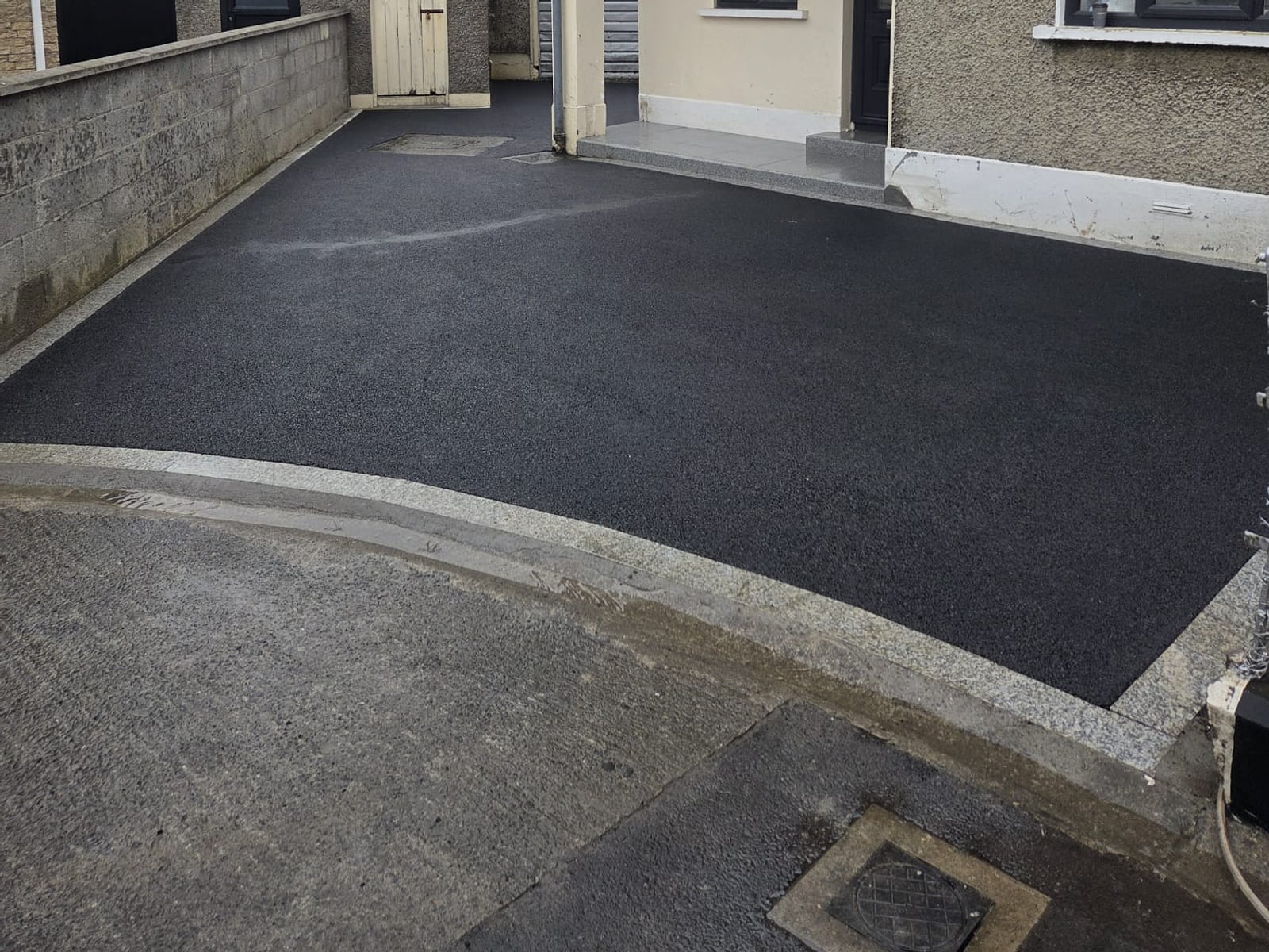 Tarmac driveway with granite kerb edging and a granite step