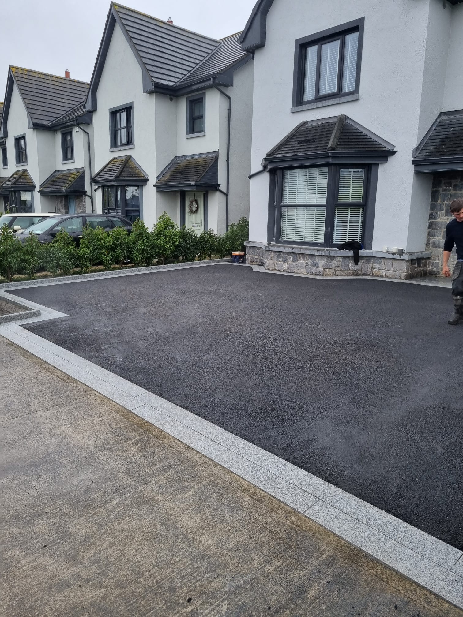 Tarmac driveway at a modern townhouse with granite kerb edging