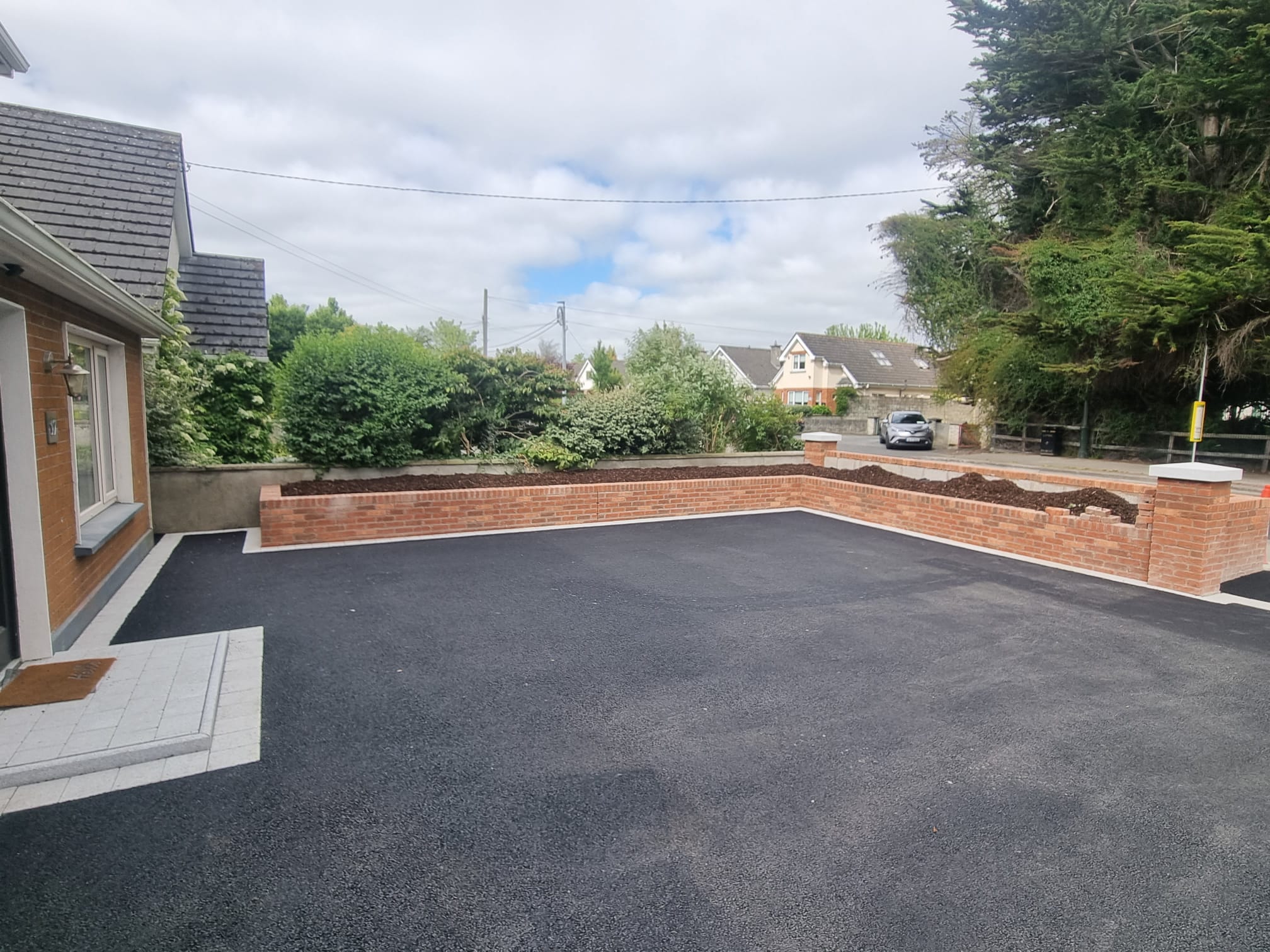Tarmac Forecourt with Brick Wall