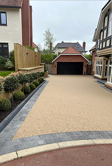 Resin bound driveway with crisp edge detail and feature paving