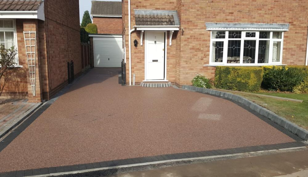Red terracotta resin bound driveway with charcoal block border